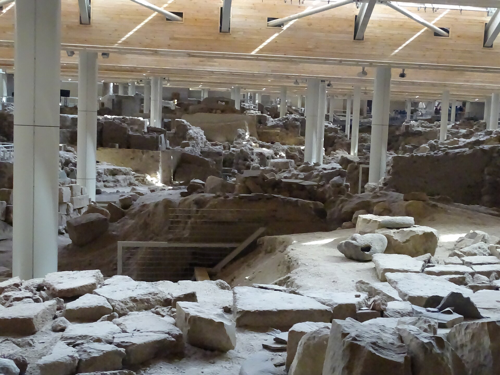 Preserved walls and rooms beneath the protective shelter at Akrotiri on Santorini